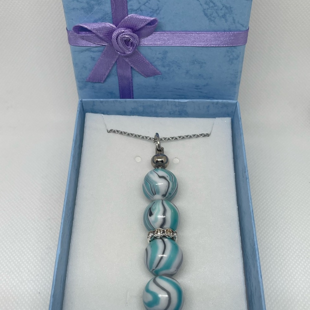 Exquisite Blue & Silver Swirl Necklace
Expertly Handcrafted, Exclusively Yours